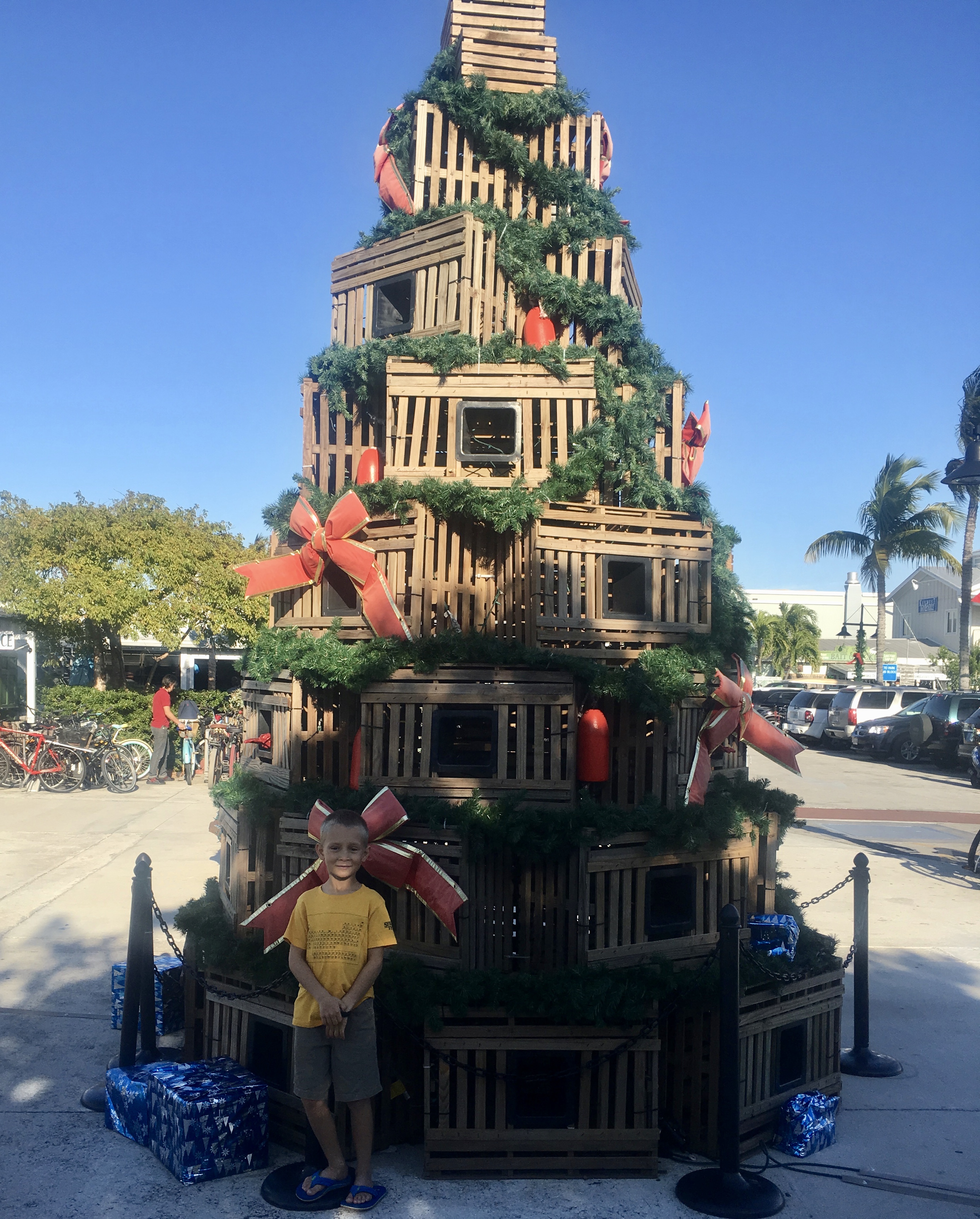 My son in front of a Christmas tree made from stacked lobster traps in Key West, Florida.