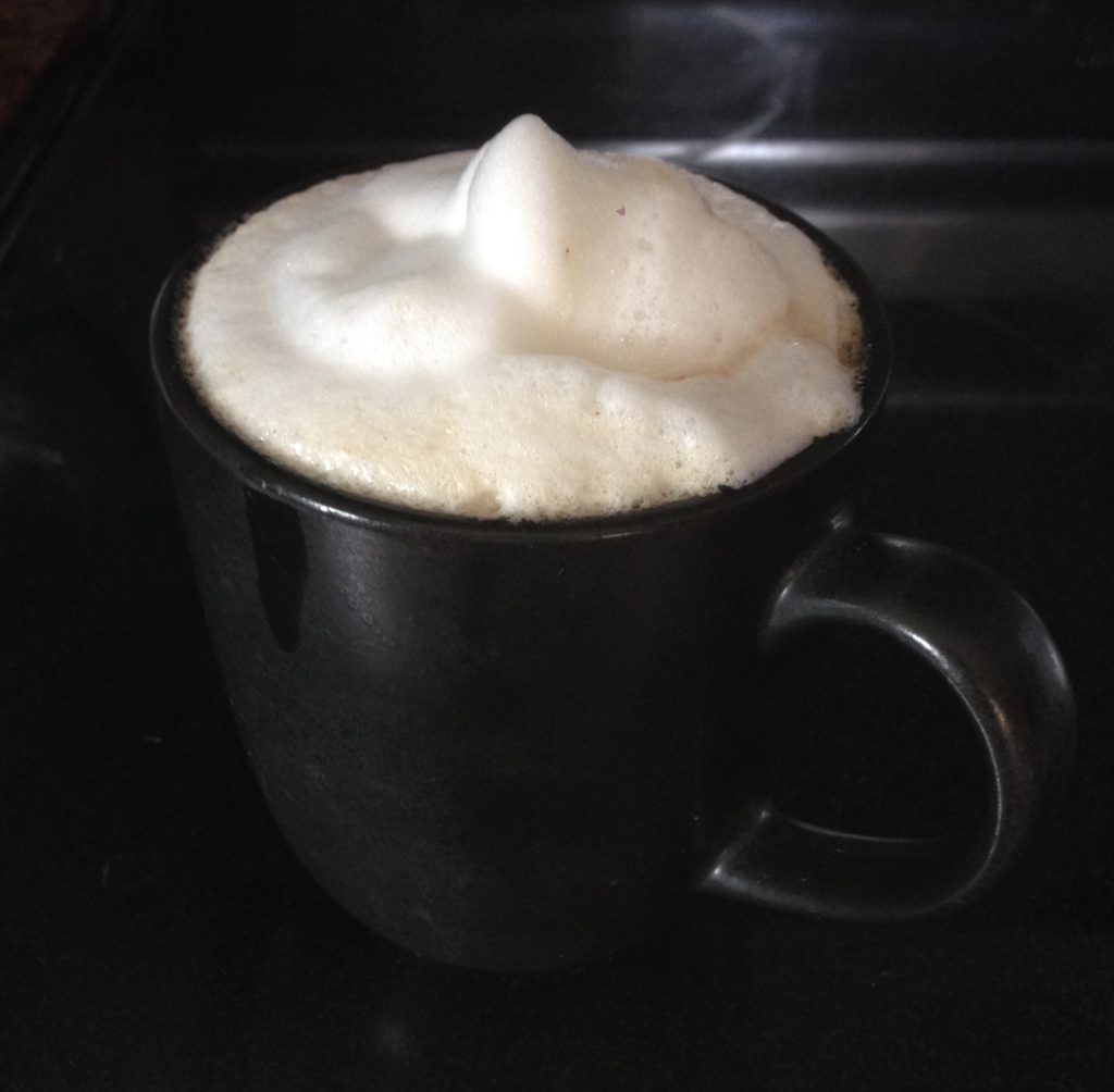 A frothy cup of coffee to start the day with calm.