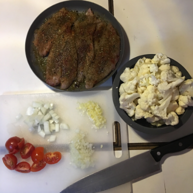 Fresh caught grouper and chopped cauliflower, tomatoes and onions ready for roasting.