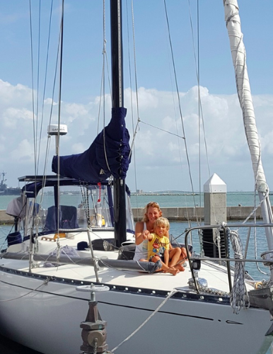 Jennifer and Wilson, her son, aboard their sailboat home, First Light.