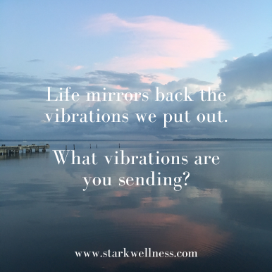 Reflective ocean view with text: Life mirrors back the vibrations we put out. What vibrations are you sending? --www.starkwellness.com